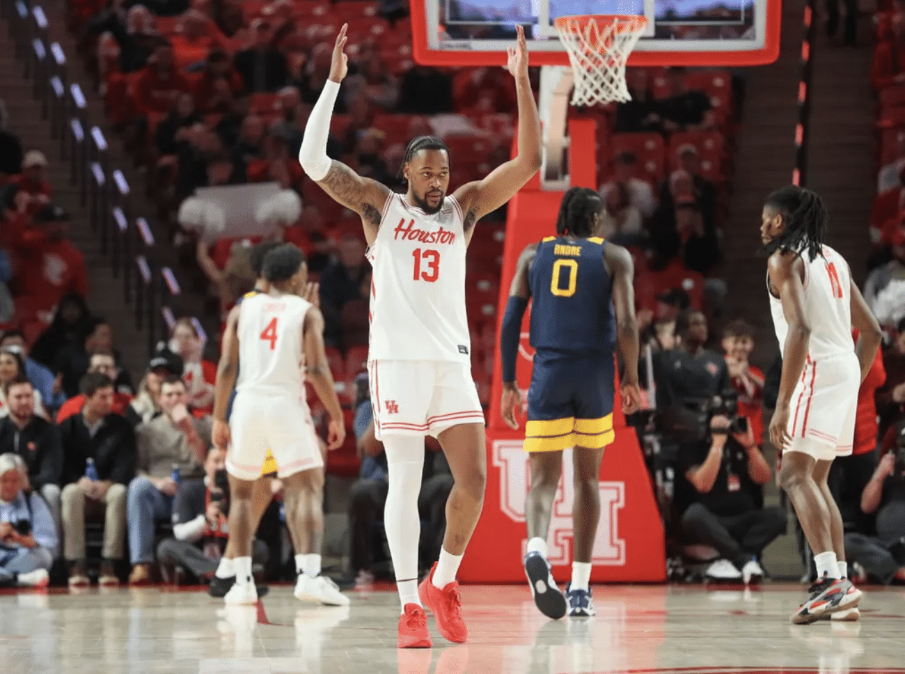 J'Wan Roberts celebrates as Houston basketball beats West Virginia (Photo credit: Stephen Pinchback Houston Athletics)